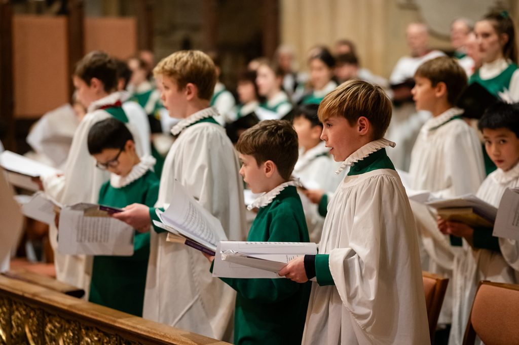 Group of boy choristers standing and singing in Bath Abbey
