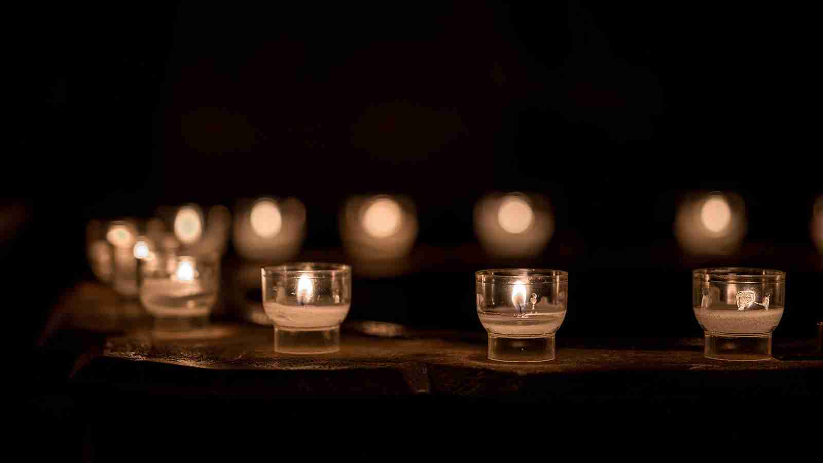 Tea lights in clear candle holders arranged in a semi circle