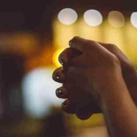 A pair of hands clasped in prayer