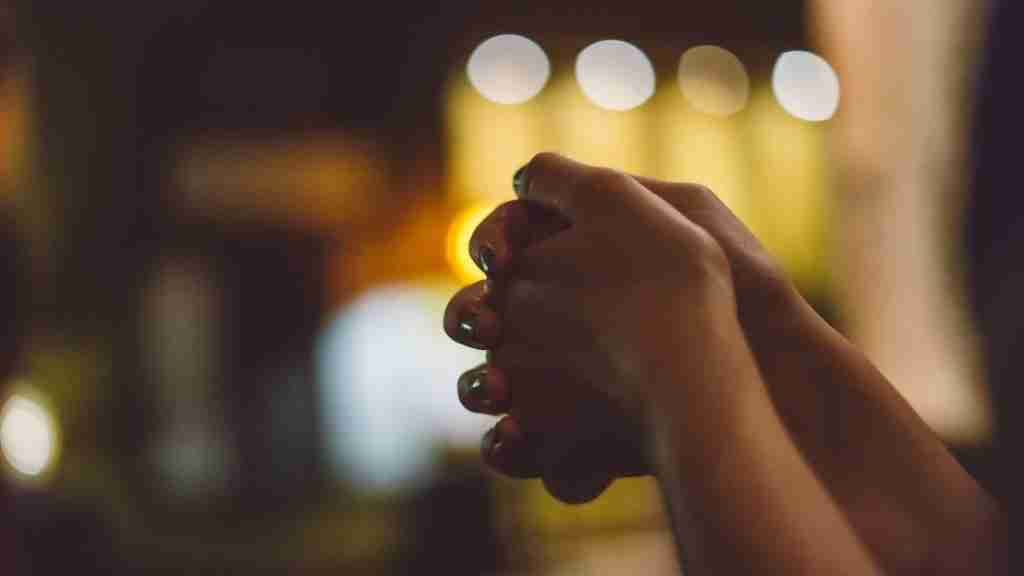 A pair of hands clasped in prayer