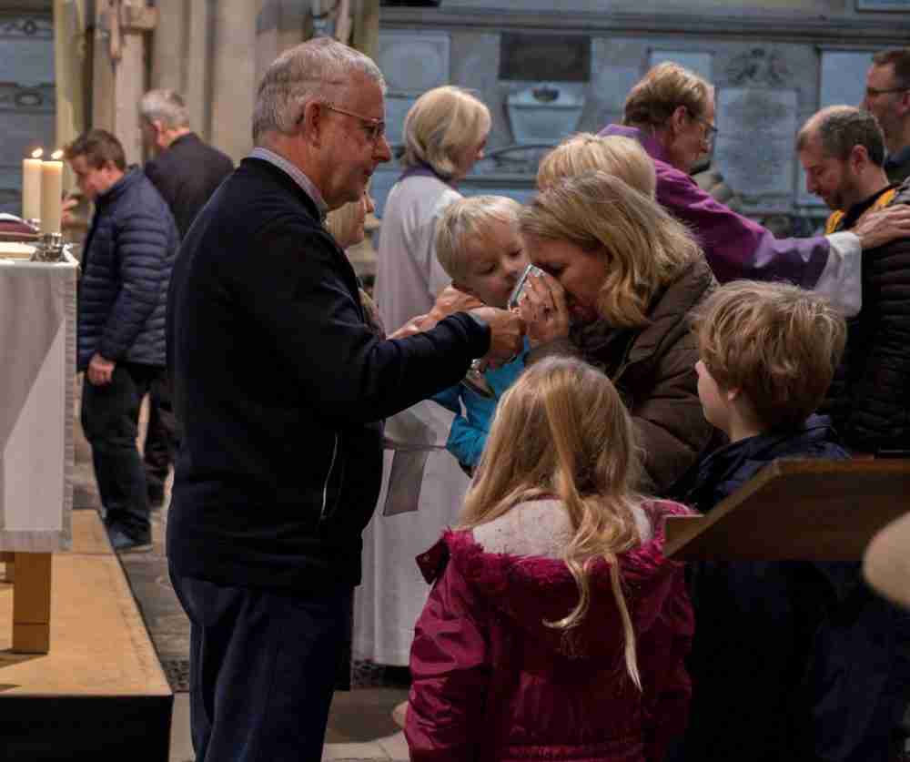 Family taking Communion at Parish Communion service