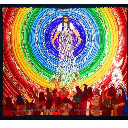 Textile artwork of Jesus surrounded by a rainbow circle, with a crowd of people facing him